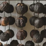 a photo of dried black limes hanging on YrLG3O WSryiKvpmHMBsCg f0AbJOdfQ8 htjNcTV hVQ