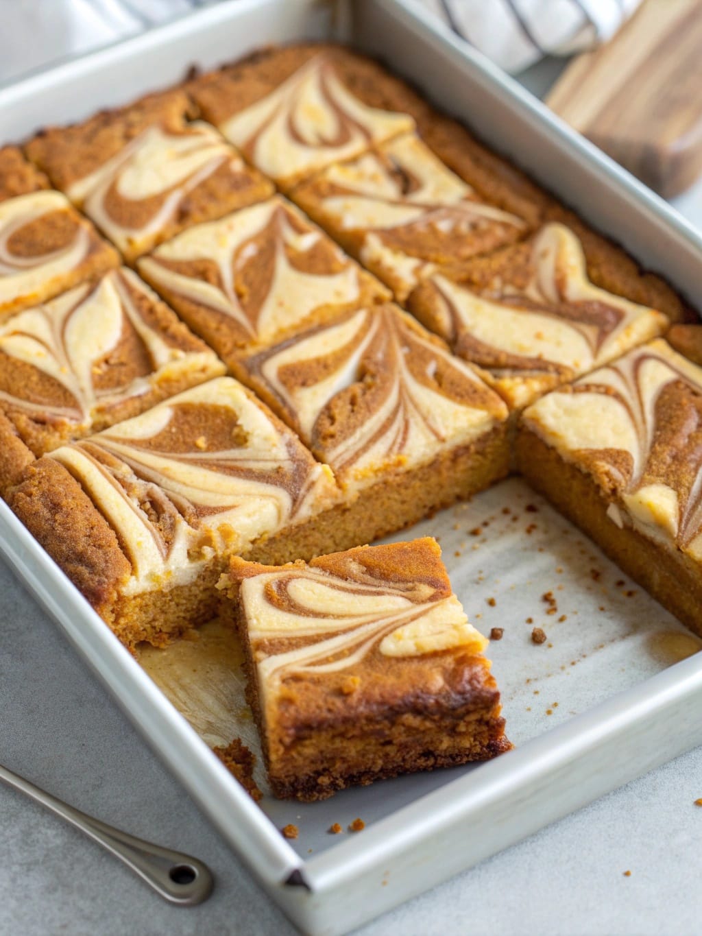 Pumpkin Cheesecake Swirl Blondie Squares with caramel drizzle