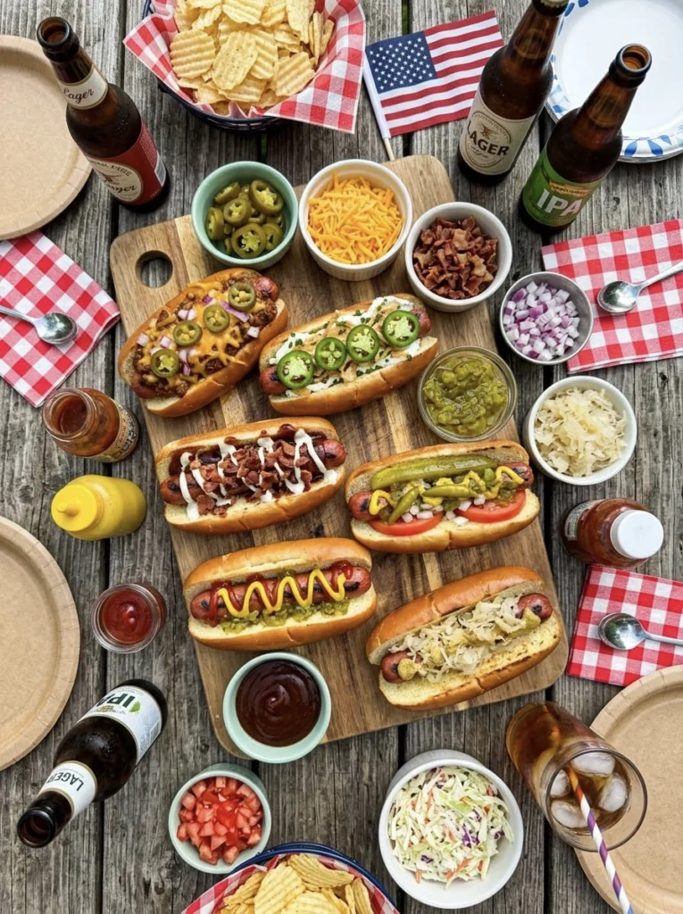 A hot dog bar in a backyard with condiments and sauces